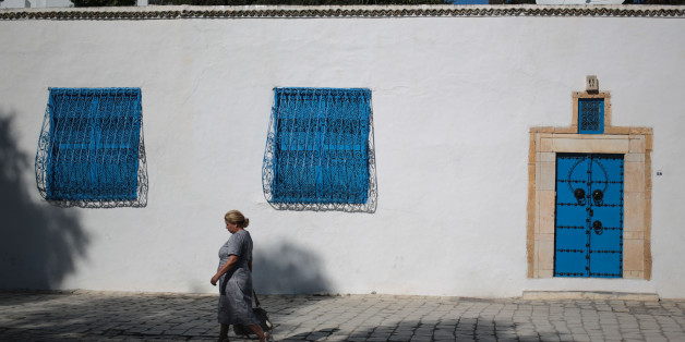 A woman walks in the city of Sidi Bou Said, 20 km north of Tunis, Tunisia, Saturday, Oct. 24, 2015. (AP Photo/Mosa'ab Elshamy)
