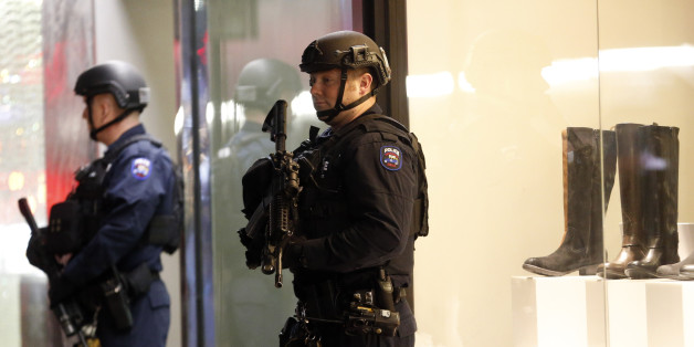 New York police officers patrol Madison Avenue during New Year's Eve celebrations, Thursday, Dec. 31, 2015, in New York. Nearly 6,000 armed police officers are guarding Times Square as the year 2015 draws to a close. (AP Photo/Julio Cortez)