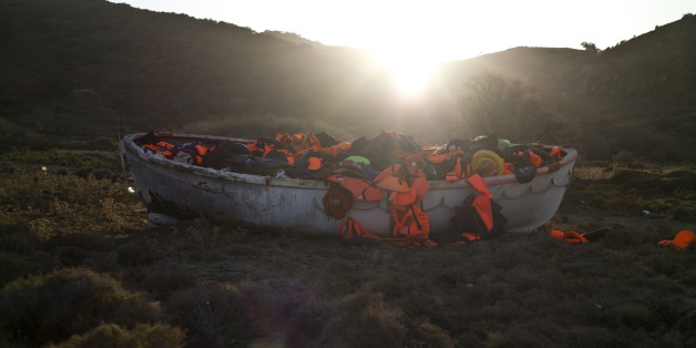A wooden boat full of life jackets used by refugees and migrants to cross the Aegean sea from the Turkish coast remains on the shore of the Greek island of Lesbos, Monday, Nov. 23 , 2015. Hundreds of migrants have been stranded at the Greek-Macedonian border for days, after Macedonia and other Balkan countries toughened criteria for crossings. (AP Photo/Muhammed Muheisen)