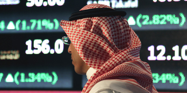 A Saudi man walks at the Tadawul Saudi Stock Exchange, in Riyadh, Saudi Arabia, Monday, June 15, 2015. Saudi Arabia's stock market, valued at $585 billion, opened up to direct foreign investment for the first time Monday, as the kingdom seeks an economic boost amid low global oil prices. (AP Photo/Hasan Jamali)