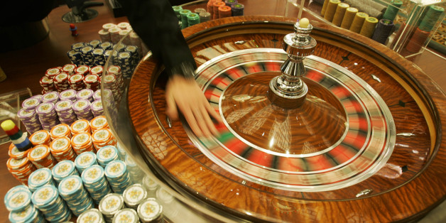 **ADVANCE FOR WEEKEND EDITIONS, MARCH 3-4** FILE ** A staff member shows photographers the gambling tables at the new casino âGrand Lisboa Casinoâ in Macau in this Feb 11, 2007 file photo. Macau - the only place in China where casinos are legal - says it's just getting started. More casinos, malls, convention centers, resorts and thousands of hotel rooms are being built in the city - about one-sixth the size of Washington, D.C. (AP Photo/Kin Cheung, file)