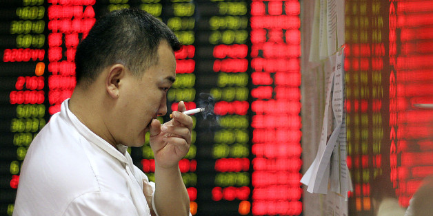 An investor checks market news on a board at a private security company Wednesday, April 9, 2008 in Shanghai, China. Chinese stocks tumbled Wednesday, with the benchmark Shanghai Composite Index shedding 5.5 percent as jittery investors unloaded shares in an afternoon sell-off. The 198.63-point decline in the Shanghai index, to 3,413.91, capped a three-day streak of advances that brought share prices back from one-year lows hit last week. (AP Photo)