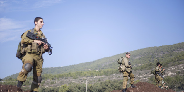 Israeli soldiers of the Golani brigade search for rockets fired from Lebanon after they landed in northern Israel, Monday, Dec. 21, 2015. sraeli officials say there's no damage or injuries after three rockets were fired into Israel from Lebanon last night. Hezbollah officials had pledged to avenge the killing of a Lebanese man killed by an Israeli airstrike on the Syrian capital Saturday night. (AP Photo/Ariel Schalit)