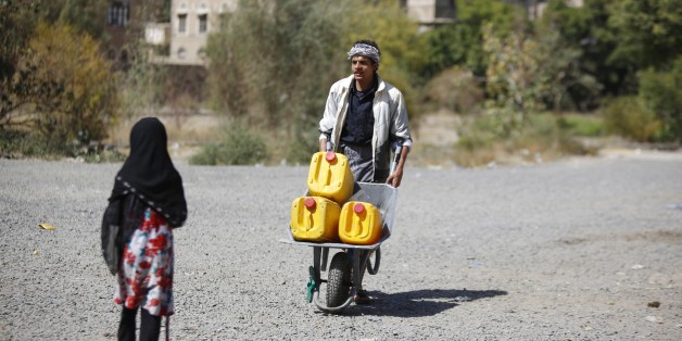 A man pushes a cart loaded buckets to fill with water from a public tap amid an acute shortage of water, in the old city of Sanaa, Yemen, Wednesday, Nov. 25, 2015. (AP Photo/Hani Mohammed)