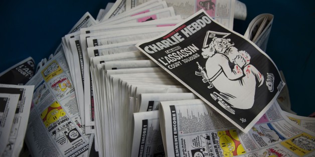A picture taken on January 4, 2016 at a printing house near Paris shows the cover of the latest edition of the French Satirical magazine Charlie Hebdo bearing a headline which translates as 'One year on: The assassin still at large' in an edition to mark the first anniversary of the terror attack which targetted the magazines offices in Paris on January 7, 2015.
One million copies of the special edition will go on sale in France on January 6, on the eve of the first anniversary of the killing of 12 people at the magazine's Paris offices by brothers Cherif and Said Kouachi. / AFP / MARTIN BUREAU (Photo credit should read MARTIN BUREAU/AFP/Getty Images)