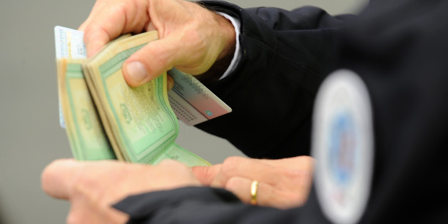 French police officers checks a person's papers at a border post on the French-Spanish border on the A63 motorway in Biriatou, southwestern France, on December 4, 2015, during a border control organized by the prefecture of the Pyrenees-Atlantiques department.
EU ministers mulled on December 4 whether to extend border checks within the passport-free Schengen zone for up to two years and pushed for the sharing of air passenger name information following the Paris attacks. / AFP / IROZ GAIZKA (Photo credit should read IROZ GAIZKA/AFP/Getty Images)