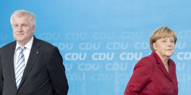 German Chancellor Angela Merkel walks besides Horst Seehofer,, left, governor of Bavaria and chairman of the CSU, during an election campaign event of the German Christian Democratic Union (CDU) in Fulda, Germany, on Thursday, Sept. 19, 2013. Merkel, the leader of the conservative Christian Democratic Union party (CDU) and top candidate of her party will be challenged by Social Democratic Party (SPD) top candidate Peer Steinbrueck at Germany's general elections on Sept. 22, 2013. (AP Photo/Jens Meyer)
