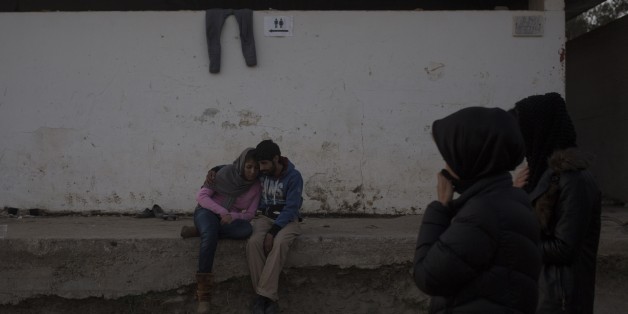 A young couple embraces outside a registration center for migrants and refugees in Moria village on the northeastern Greek island of Lesbos, Wednesday evening, Nov. 18, 2015. European leaders pressed ahead with efforts to discourage people from heading to Europe to find work and kept seeking ways to send back home thousands who don't qualify for asylum. (AP Photo/Santi Palacios)