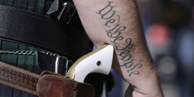 FILE - In this Jan. 26, 2015, file photo, Scott Smith, a supporter of open carry gun laws, wears a pistol as he prepares for a rally in support of open carry gun laws at the Capitol, in Austin, Texas. Despite its reputation as the trigger-happy heart of American gun culture, Texas is late to the open carry party, at least when it comes to handguns. On New Yearâs Day, itâll become the 45th state to legalize carrying a pistol in plain sight. (AP Photo/Eric Gay, File)