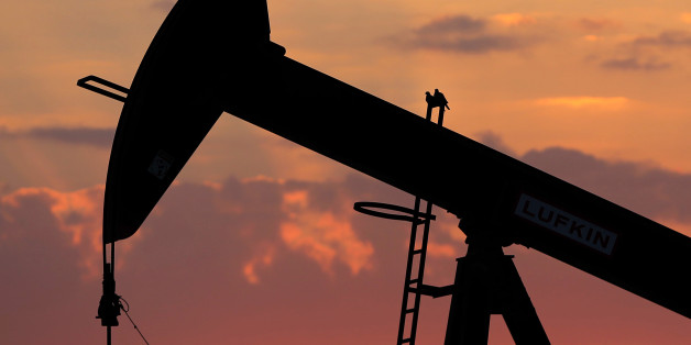 Doves sit on an oil pump at sunset in the desert oil fields of Sakhir, Bahrain, Sunday, Dec. 13, 2015. Gasoline prices remain low in the United States and are expected to soon drop below US$2 a gallon. (AP Photo/Hasan Jamali)