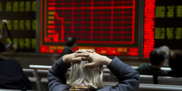 A woman reacts near a display board showing the plunge in the Shanghai Composite Index at a brokerage in Beijing, China, Thursday, Jan. 7, 2016. Chinese stocks nosedived on Thursday, triggering the second daylong trading halt of the week and sending other Asian markets sharply lower as investor jitters rippled across the region. (AP Photo/Ng Han Guan)