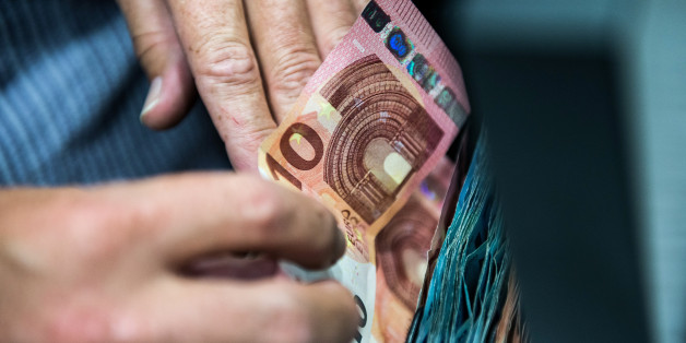 A shopkeeper places a 10 euro banknote into a cash till drawer inside a general store in Vienna, Austria, on Wednesday, Aug. 26, 2015. The euro has surged almost 4 percent against a basket of developed-nations peers in the past month, the biggest gain in the group. Photographer: Akos Stiller/Bloomberg via Getty Images