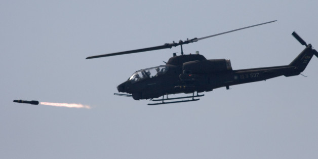A U.S. made AH-1W attack helicopter launches a Hellfire missile during the annual Han Kuang No. 22 exercises, Thursday, July 20, 2006, in Ilan, 80 kilometers (49 miles) west of Taipei, Taiwan. The goal of the exercises is to test the joint combat capability of the Taiwanese armed forces to fend off a Chinese offensive. Taiwan split from China in 1949 amid civil war and China hasn't ruled out the use of force to unify the island. (AP Photo)