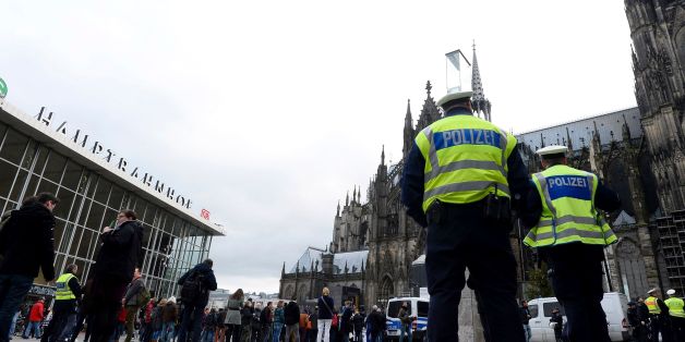 Police officers survey the area in front of the main train station and the Cathedral in Cologne, western Germany, on January 6, 2016, where dozens of apparently coordinated sexual assaults were perpetred against women on New Year's Eve. / AFP / Roberto Pfeil (Photo credit should read ROBERTO PFEIL/AFP/Getty Images)
