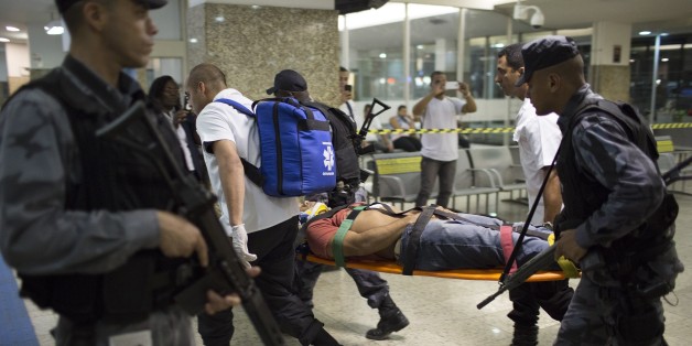 Police and rescue workers carry a fellow officer on a stretcher during a security drill that simulated a store robbery at the Novo Rio bus station in Rio de Janeiro, Brazil, Thursday, Oct. 1, 2015. Police also practiced handling a bus hijacking that involved hostage negotiation. (AP Photo/Leo Correa)