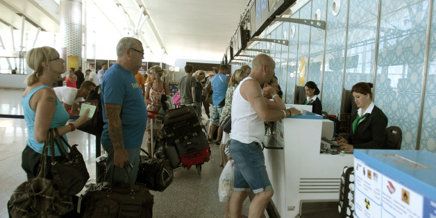 Tourists line up at a boarding desk as the leave Sousse, Tunisia, after the attack, Saturday June 27, 2015 at the Nfidha airport near Sousse. Tunisiaâs prime minister announced on Saturday a string of new security measures including closing renegade mosques and calling up army reservists as thousands of tourists left the North African country in wake of its worst terrorist attack ever. (AP Photo/Salah Rhim)