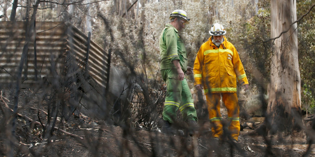 MELBOURNE, AUSTRALIA - DECEMBER 27: Crew Leader of DELWP (Department of Environment, Land, Water & Planning) at Wye River Alex Shilton and Deputy Group Officer from Camperdown Group Ray Place inspect the damage to homes at Separation Creek on December 27, 2015 in Melbourne, Australia. Over 116 homes in the Wye River area along Victoria's Great Ocean Road were destroyed on Christmas Day. The fire started from a lightning strike in the area on December 19. (Photo by Darrian Traynor/Getty Images)