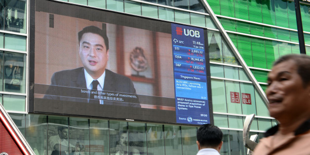 A big screen displays information on the stock index at the Raffles Place financial district in Singapore on January 11, 2016. Asian shares tumbled again on January 11 as another round of tepid data added to concerns about China's economy, which is already responsible for sparking a rout across global markets at the start of the year. AFP PHOTO / ROSLAN RAHMAN / AFP / ROSLAN RAHMAN (Photo credit should read ROSLAN RAHMAN/AFP/Getty Images)
