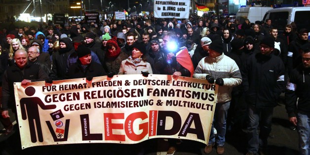 LEIPZIG, GERMANY - JANUARY 21 A group of people led by LEGIDA, Leipzig's local copycat of far right movement PEGIDA (Patriotic Europeans Against the Islamisation of the Occident), hold poster and banners during a demonstration in Leipzig, Germany on January 21, 2015. (Photo by Mehmet Kaman/Anadolu Agency/Getty Images)