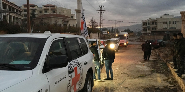 This picture provided by The International Committee of the Red Cross (ICRC), working alongside the Syrian Arab Red Crescent (SARC) and the United Nations (UN), shows a convoy containing food, medical items, blankets and other materials being delivered to the town of Madaya in Syria, Monday, Jan. 11, 2016. The town, about 15 miles (24 kilometers) northwest of Damascus, has been blockaded for months by government troops and the Lebanese militant group Hezbollah. Opposition activists and aid groups have reported several deaths from starvation in recent weeks. (ICRC via AP)
