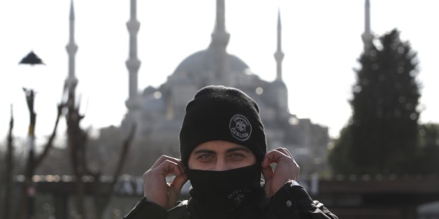 Backdropped by the Sultan Ahmed Mosque, better known as the Blue Mosque in the historic Sultanahmet district of Istanbul, a police officer secures the area after an explosion, Tuesday, Jan. 12, 2016 The explosion killed several people and wounded 15 others Tuesday morning in a historic district of Istanbul popular with tourists. Turkish President Recep Tayyip Erdogan said a Syria-linked suicide bomber is believed to be behind the attack. (AP Photo/Lefteris Pitarakis)