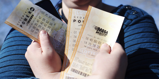 Stephanie Barnett, of Center Point, Ala., holds up Powerball lottery tickets at Georgia Visitor Information Center, Wednesday, Jan. 13, 2016, in Tallapoosa, Ga. "If I win, I want to build a new house," says Barnett. (AP Photo/Brynn Anderson)