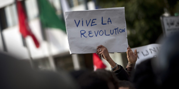 A board reading "Long live revolution" is seen during a demonstration against the Constitutional Democratic Rally (RCD) party of deposed President Zine El Abidine Ben Ali, in the center of Tunis, Wednesday, Jan. 19, 2011. (AP Photo/Thibault Camus)