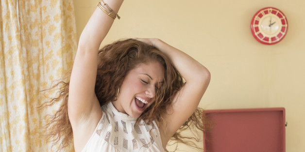 USA, New Jersey, Jersey City, Portrait of woman dancing happily in room