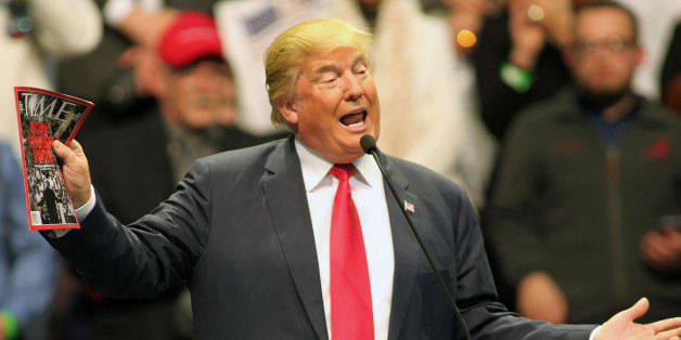 Republican presidential candidate Donald Trump holds a copy of Time Magazine as he speaks during a campaign rally at the Pensacola Bay Center in Pensacola, Fla., Wednesday, Jan. 13, 2016. (AP Photo/Michael Snyder)