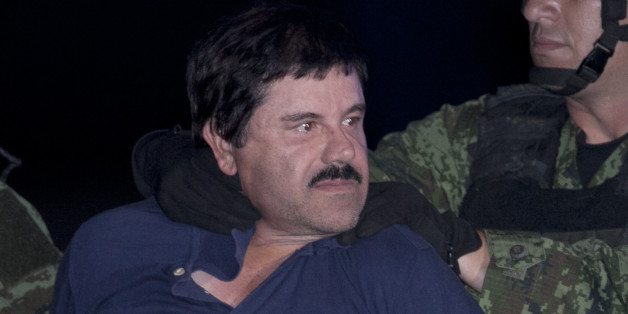 Joaquin "El Chapo" Guzman is made to face the press as he is escorted to a helicopter in handcuffs by Mexican soldiers and marines at a federal hangar in Mexico City, Mexico, Friday, Jan. 8, 2016. Mexican President Enrique Pena Nieto announced that Guzman had been recaptured six months after escaping from a maximum security prison. (AP Photo/Marco Ugarter)