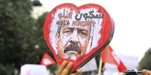 Demonstrators hold a poster showing slain opposition leader Chokri Belaid with written in arabic and french "Who Killed Him" during aTunisian demonstration on Habib Bourguiba avenue in downtown Tunis, Saturday, Feb. 23, 2013. Thousands of Tunisians joined a protest that started as a demonstration against what they described as a slow investigation into the death of assassinated opposition leader Chokri Belaid. (AP Photo/Amine Landoulsi)