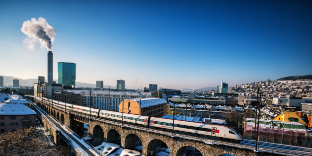 Zurich cityscape with SBB train in winter and snow. Prime Tower visible in the background.