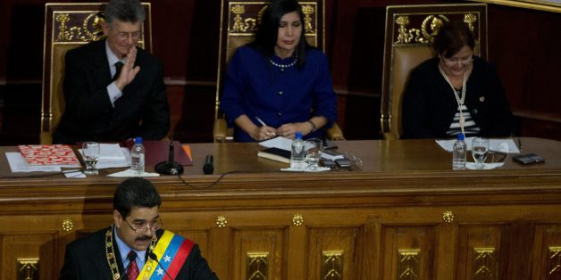 Venezuela's President Nicolas Maduro, bottom left, points to a opposition lawmaker during his annual state of the nation report in Caracas, Venezuela, Friday, Jan. 15, 2016. Above left to right, Henry Ramos Allup, President Of the National Assembly, Gladys Gutierrez , President of the Supreme Court and Tibisay Lucena the President of national Electoral Council. Ahead of a surprise dire economic data release, Maduro said he would declare an economic emergency giving him 60 days to unilaterally e