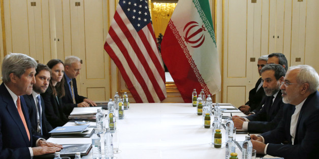 U.S. Secretary of State John Kerry, left, meets with Iranian Foreign Minister Mohammad Javad Zarif, right, in Vienna, Austria, Saturday, Jan. 16, 2016, on what is expected to be "implementation day," the day the International Atomic Energy Agency (IAEA) verifies that Iran has met all conditions under the nuclear deal. (Kevin Lamarque/Pool Photo via AP)