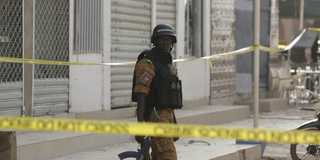 A soldier stand guards outside the Splendid Hotel in Ouagadougou, Burkina Faso, Saturday, Jan. 16, 2016. The overnight seizure of a luxury hotel in Burkina Faso's capital by al-Qaida-linked extremists ended Saturday when Burkina Faso and French security forces killed four jihadist attackers and freed more than 126 people, the West African nation's president said. (AP Photo/Sunday Alamba)