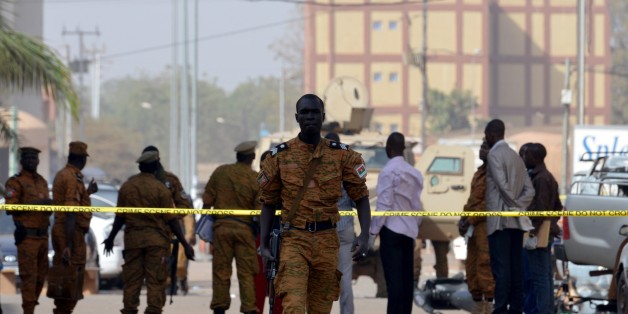 Burkina Faso's soldiers and investigators gather in front of the Splendid hotel and the cafe restaurant Capuccino on January 17, 2016 in Ouagadougou, following a jihadist attack by Al-Qaeda linked gunmen late on January 15. At least 29 people, including at least 12 foreigners, were killed in an Al-Qaeda attack on a top hotel in Burkina Faso, an unprecedented strike in the capital illustrating the expanding reach of regional jihadists. / AFP / ISSOUF SANOGO (Photo credit should read ISSOUF
