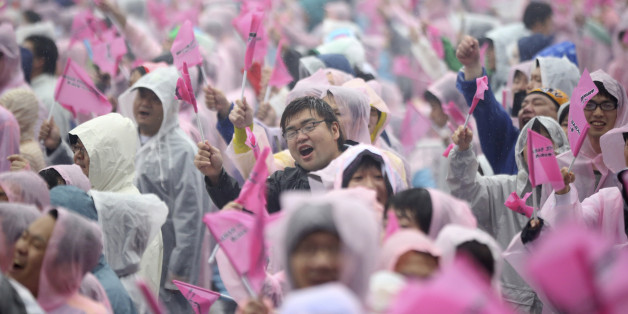 Fans of Japanâs all-girl pop idol group AKB48 cheer as the group performs prior to the annual AKB48 popularity poll in Tokyo, Saturday, June 7, 2014. In the event, fans vote their favorite group member. (AP Photo/Eugene Hoshiko)