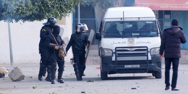 Tunisian riot policemen deploy during clashes following protests after the death of an unemployed man in the central city of Kasserine on January 20, 2016. Tunisian police fired tear gas and water cannon to disperse hundreds of job-seeking demonstrators in the impoverished town of Kasserine, in a second day of protests. The demonstrators had gathered outside the governorate's offices demanding a solution to the region's dire unemployment before heading towards the town centre, as small groups s