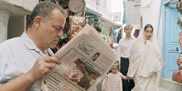 An unidentified Tunisian reads news of the ongoing meetings of the Fatah faction of the Palestinian Liberation Organization in a local newspaper in the old part of Tunis on Sept. 3, 1993. PLO head Yasser Arafat is trying to win the approval of key Palestinian leaders for a landmark accord with Israel. (AP Photo/Francois Mori)