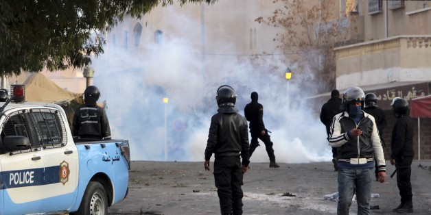 Police forces stand by tear gas during clashes in the city of Ennour, near Kasserine, Tunisia, Wednesday, Jan. 20, 2016. Tunisia has declared a curfew in the western city after clashes between police and more than 1,000 young protesters demonstrating for jobs. Tensions have risen in Kasserine since Sunday when an unemployed youth killed himself by scaling an electricity transmission tower to protest his rejection for a government job. (AP Photo/Moncef Tajouri)