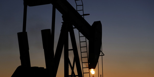 An oil pump works at sunset Monday, Jan. 18, 2016, in the desert oil fields of Sakhir, Bahrain. Iran is aiming to increase its oil production by 500,000 barrels per day now that sanctions have been lifted under a landmark nuclear deal with world powers, a top official said. (AP Photo/Hasan Jamali)