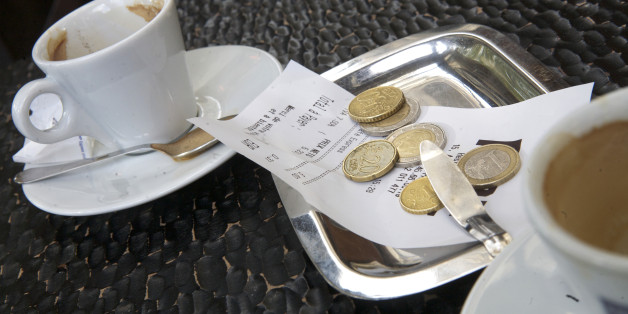 Euro coins left to pay for a coffee at a cafe