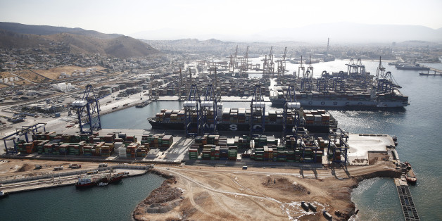 Container ships sit beneath gantry cranes at the COSCO Pacific Ltd. terminal at Piraeus port, operated by Piraeus Container Terminal SA (PCT), in Athens, Greece, on Thursday, June 25, 2015. Greece could tap euro-area funds of as much as 3.35 billion euros ($3.75 billion) by early July if it can reach a deal with its creditors, thanks to profit-sharing pledges from member nations' central banks. Photographer: Simon Dawson/Bloomberg via Getty Images