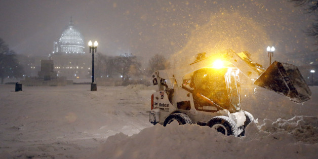 A bobcat piles up snow in front of the U.S. Capitol, as the snow continues to fall, Friday, Jan. 22, 2016, in Washington. (AP Photo/Alex Brandon)