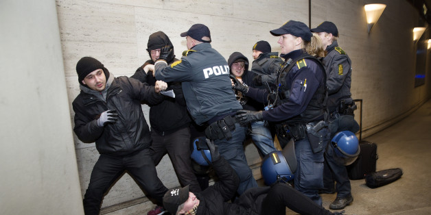 Members of 'Refugees are Welcome' react with police as they demonstrate against the Swedish control of identification from travelers and migrants, at Copenhagen International Airport in Kastrup, Denmark, Saturday, Jan. 9 2016. Sweden requires train companies offering a service across a bridge-and-tunnel link from Denmark to refuse passengers without IDs. (Thomas Borberg/ Polfoto via AP) DENMARK OUT
