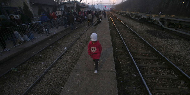 A migrant child walks along the side of railway tracks at the railway station in the southern Serbian town of Presevo, Wednesday, Dec. 23, 2015. As 2015 ends, boat-loads continue to reach the shores of Greek islands from the nearby Turkish coast, while thousands of migrants unlikely to receive refugee status are stranded along the Balkan migrant route, their hopes of reaching the prosperous northern EU countries in jeopardy. (AP Photo/Darko Vojinovic)