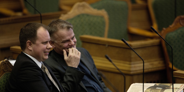 Martin Henriksen, left, and Christian Langballe from The Danish People's Party, sit in Parliament, in Copenhagen on Tuesday Jan. 26, 2016. Denmark's Parliament is expected to vote allow police seizing valuables worth more than $1,500 from asylum-seekers to help cover their housing and food costs while their cases were being processed. (Peter Hove Olesen/ POLFOTO via AP) DENMARK OUT