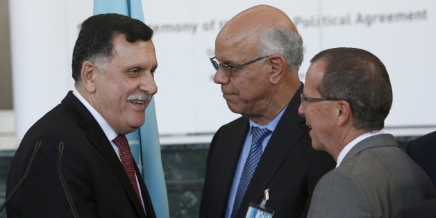 Fayez Sarraj, Libyan Prime Minister, left, chats with Mohammed Chouaib, head of delegation from the UN-recognized government in the eastern city of Tobruk, Libya, center, as UN Special Envoy to Libya, Martin Kobler, right, looks on after signing a U.N.-sponsored deal aiming to end Libya's conflict Thursday , Dec.17, 2015 in Skhirat, Morocco. (AP Photo/Abdeljalil Bounhar)
