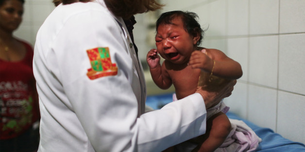 In this Dec. 23, 2015 photo, Solange Ferreira bathes her son Jose Wesley in a bucket of water, which she says he enjoys and helps calm him, at their home in Poco Fundo, Brazil. Ferreira had never heard of microcephaly before her youngest son was diagnosed a couple of days after his birth. She became one of hundreds of Brazilian women infected during pregnancy with a mosquito-borne virus that researchers suspect causes brain damage in fetuses. (AP Photo/Felipe Dana)
