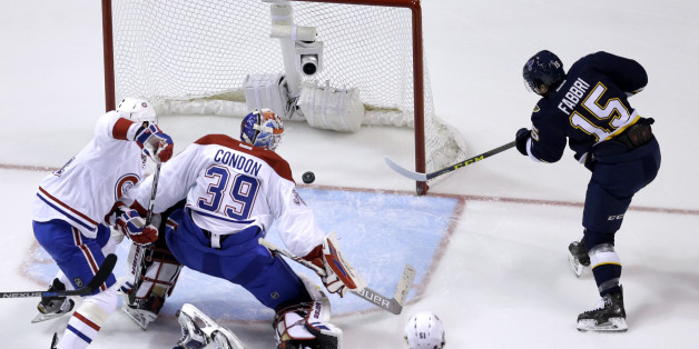 St. Louis Blues' Robby Fabbri, right, scores past Montreal Canadiens goalie Mike Condon (39) and Alexei Emelin, left, of Russia, during the first period of an NHL hockey game Saturday, Jan. 16, 2016, in St. Louis. (AP Photo/Jeff Roberson)